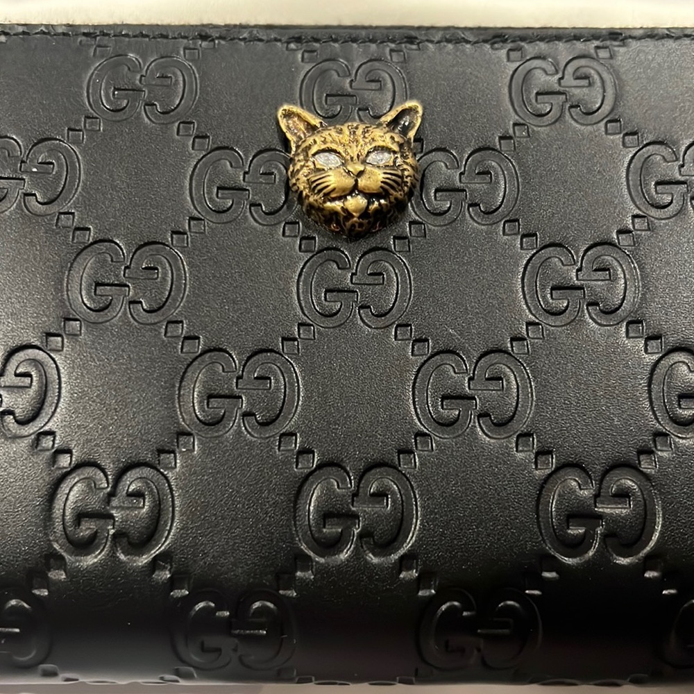 GUCCI black embossed zip around wallet. Brand new with dust bag and original box
